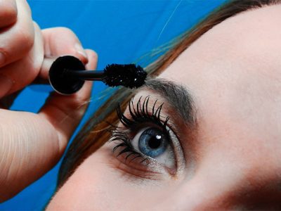 Woman applying black mascara