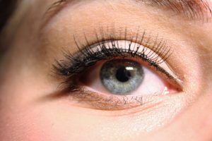 Woman's blue eyes wearing a false eye lashes