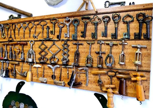 antique collection of bottle openers mounted on the wall