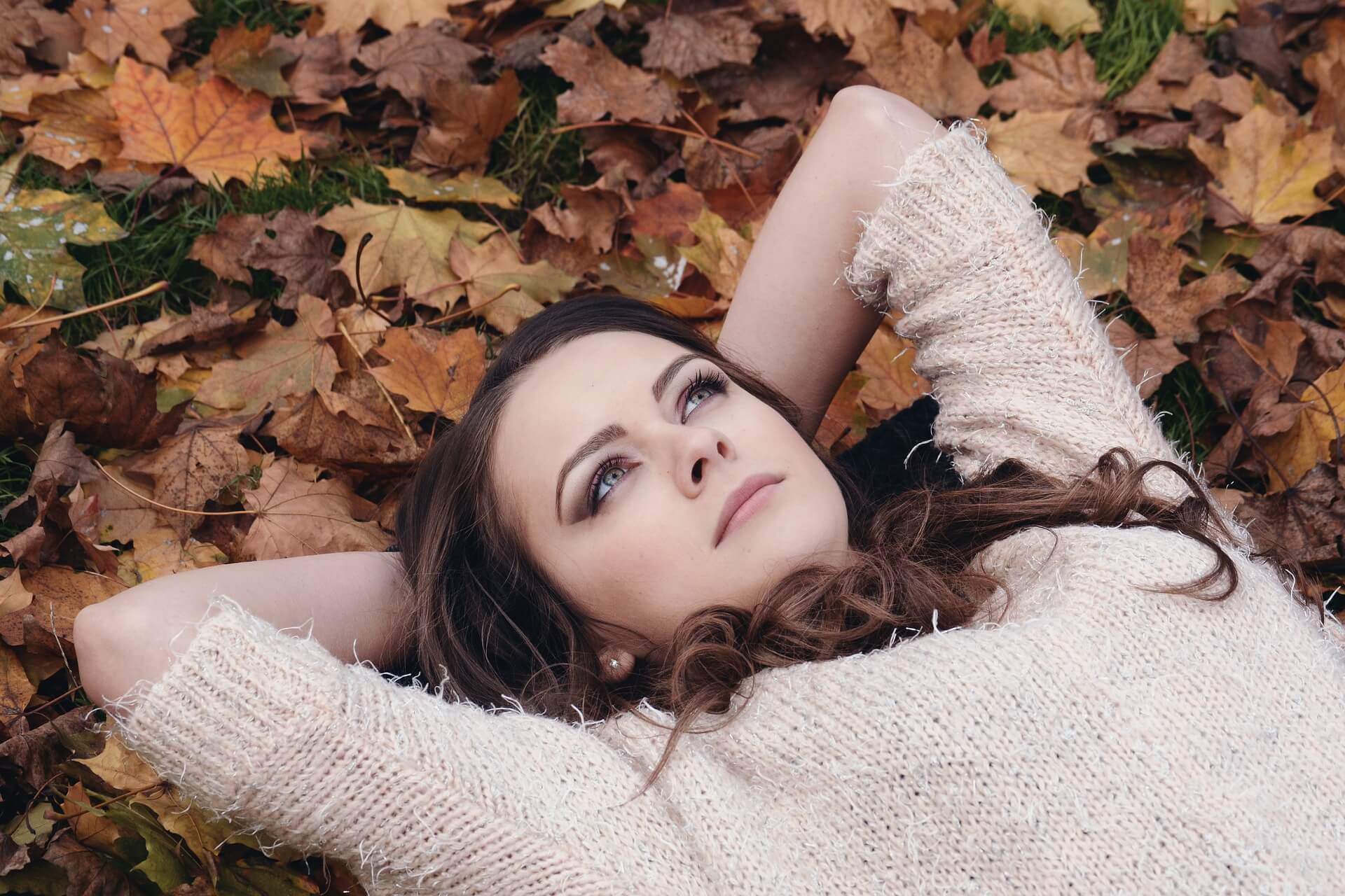 pretty lady laying on dead leaves